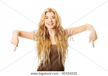 Happy student woman pointing down.