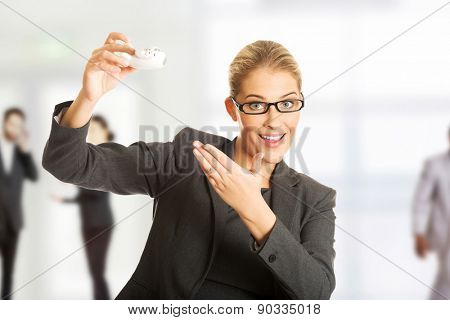 Beautiful businesswoman with plane toy in hand.