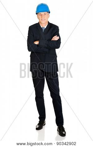 Mature confident businessma with a helmet.