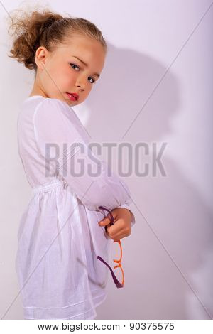 Blond girl with crossed arms and glasses in the hand