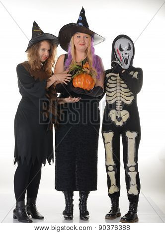Three women witches posing in scary outfits