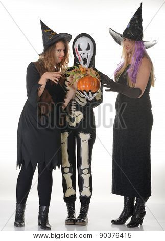 Three women witches posing in scary outfits
