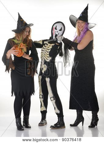 Three women witches posing in scary outfits