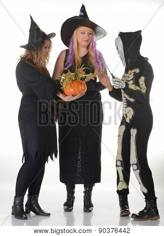 Three women witches posing in scary outfits