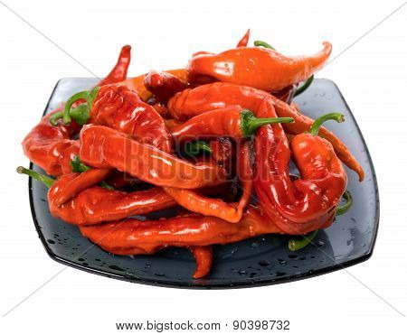 Wet Red Chili Peppers On Glass Plate