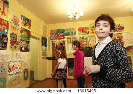 MOSCOW DECEMBER 24 2015: Unidentified art school student boy participate in final painting exhibition at the end of school trimester in Russia Moscow December 24 2015