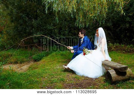 bride and groom fishing together - romantic wedding concept.