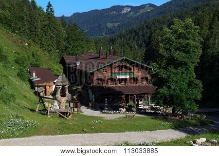 Alpine club hut Anton Karg Haus with forest and mountains in the background