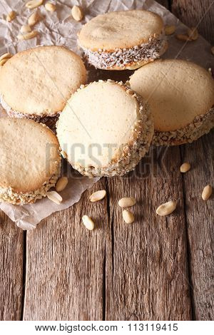 Argentine Cuisine: Alfajores With Cream On Paper Close-up. Vertical