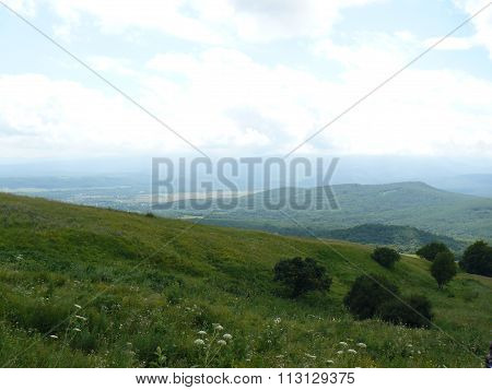 The Blossoming Meadows On Slopes Of Hills.