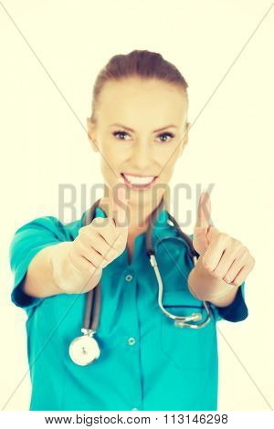 Beautiful smiling woman doctor with thumbs up.