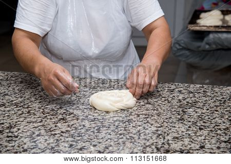 Close Up Of Female Hands Kneading Dough And Making Banitsa