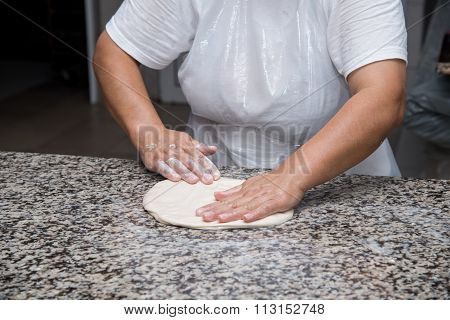 Close Up Of Female Hands Kneading Dough And Making Banitsa
