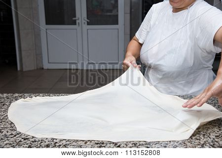 Close Up Of Female Hands Kneading Dough And Making Banitsa