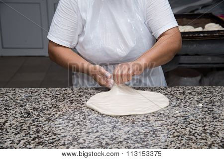 Close Up Of Female Hands Kneading Dough And Making Banitsa