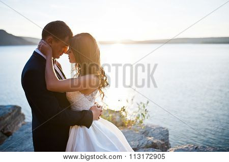 Very Sensual And Gorgeus Wedding Couple On The Picturesque Landscapes On Sunset
