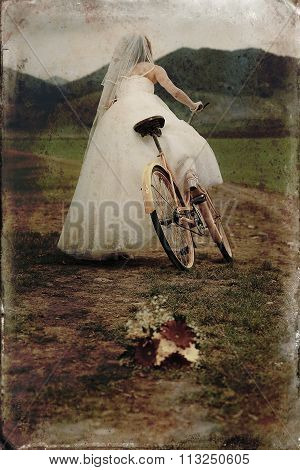 bride on orange bike in beautiful wedding dress with lace in landscape. with wedding bouquet. Retro