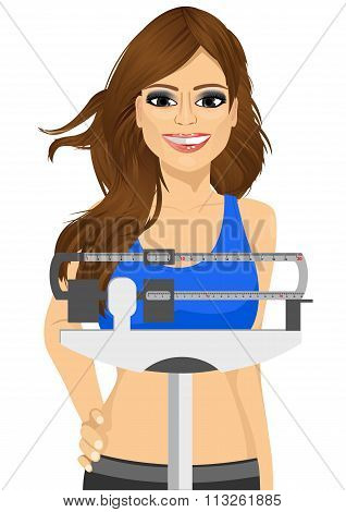 woman using a weighing scale to measure her weight