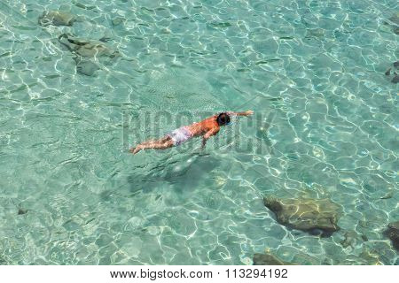 Top View Of A Boy Swimming At Milos, In Greece