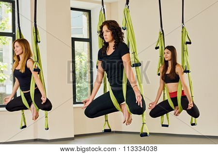 Antigravity yoga exercise. girls indoor