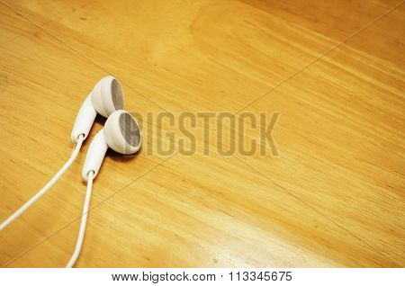 beautiful earplugs on wood surface with color filters vintage