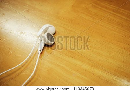 beautiful earplugs on wood surface with color filters vintage