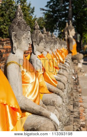 row of Buddha sculptures at Wat Yai Chai Mongkon in Ayutthaya, Thailand