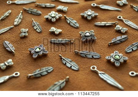 Metal beads pendants and feathers on suede