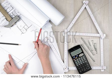 Hands Of Engineer Working With The Tool On Project Drawings Background