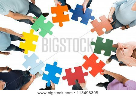 Creative Business Team Holding Colorful Jigsaw Pieces