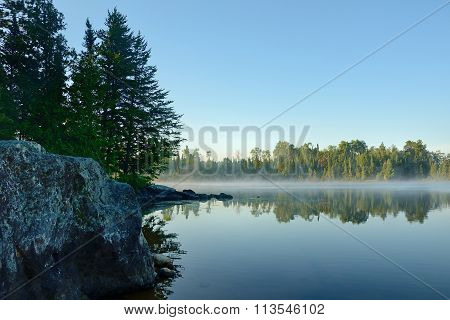 Morning Reflections On A Foggy Wilderness Lake
