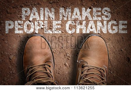 Top View of Boot on the trail with the text: Pain Makes People Change