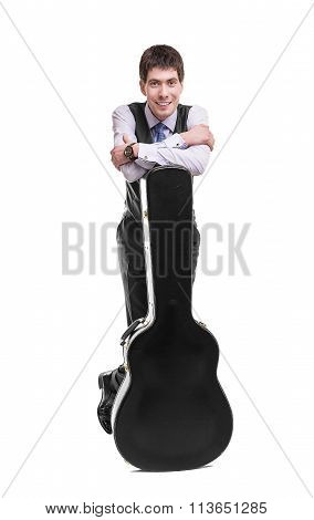 Musican with acoustic guitar in case.