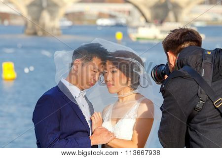 Prague. A pair of newlyweds on the banks of the Vltava.