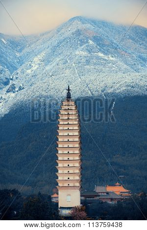 Ancient pagoda in Dali old town with snow capped Mt Cangshan, Yunnan, China.