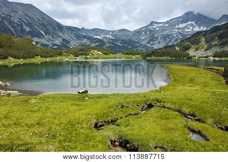 Panoramic view of Banderishki Chukar peak and reflection in Muratovo lake, Pirin Mountain