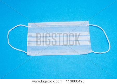 Surgical Ear-loop Mask On Blue Background