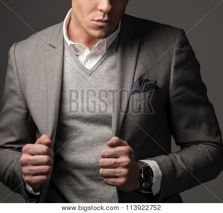 Confident sharp dressed man in grey suit 