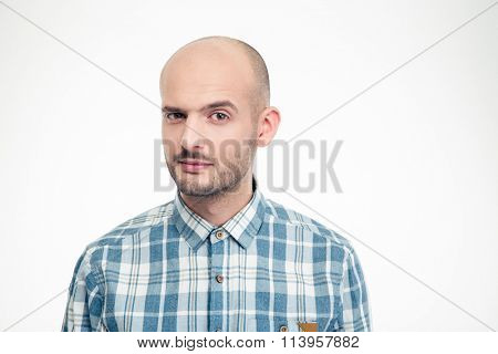 Portrait of handsome young male in plaid shirt with raised eyebrow isolated over white background