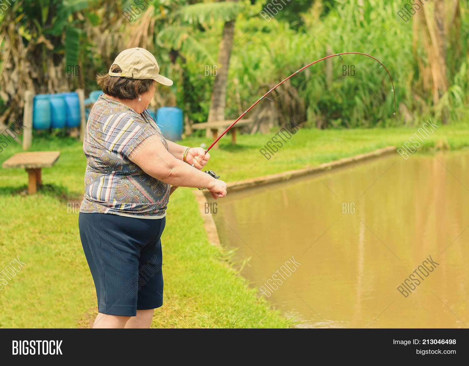 Girl With Fishing Rod Fishing In The Pond Stock Photo - Download