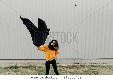 Portrait Of Stylish Modern Young Curly Woman In Coat Sunglasses