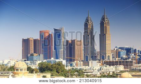 Dubai business centre. Dubai downtown on blue sky background. Skyscrapers of Dubai.