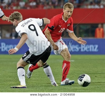 VIENNA,  AUSTRIA - JUNE 3 Andre Schuerrle (#9, Germany) and Daniel Royer (#18, Austria) fight for the ball during the EURO 2012 soccer game on June 3, 2011 in Vienna, Austria. Austria loses 1:2