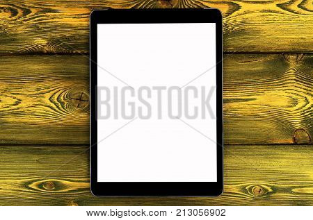 Tablet computer PC with blank screen mock up isolated on yellow wooden table background. Tablet computer on wood table. Tablet white screen