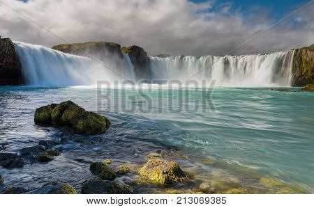 Summer picture of one of the most spectacular waterfalls in Iceland - Godafoss. Cloudy day with sun