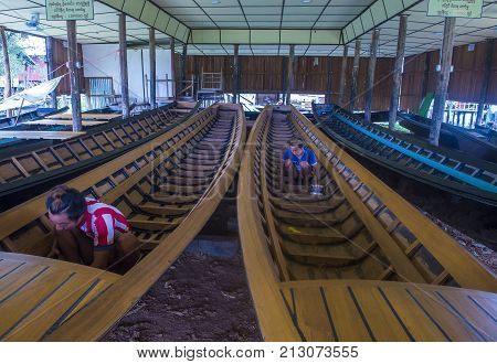 INLE LAKE MYANMAR - SEP 07 : A Burmese man building a boat in Inle lake Myanmar on September 07 2017 inle Lake is a freshwater lake located in Shan state