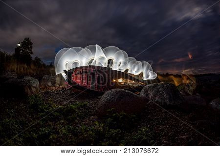 Lighthouse and house in the Baltic Sea. Shore evening light sunset clouds and architecture concept. Mohni small island in Estonia Europe.