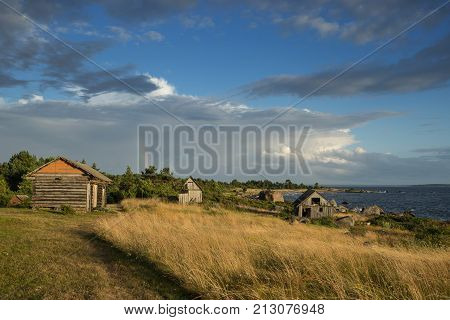 Abandoned houses in the Baltic Sea. Shore nature and ruins facilities architecture concept. Mohni small island in Estonia Europe.