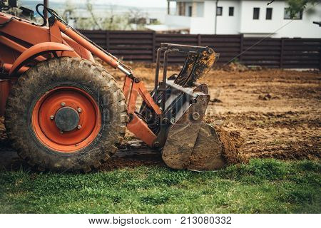 Close Up Of Industrial Bulldozer Scoop Moving Earth And Doing Landscaping Works