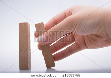 Hand Holding Wooden Domino